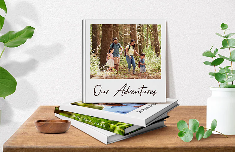 Hardcover Personalised Photo Books by Printerpix|Custom printed Printerpix photo album with hard cover and large photos of old couple|Personalised photo album book with romantic pictures of a couple and photo cover|Family photo album with custom printed cover and family name text|Pet and woman looking at personalised family photo book with custom design|Two people looking at Printerpix custom photo book with wedding photos and bride|||||