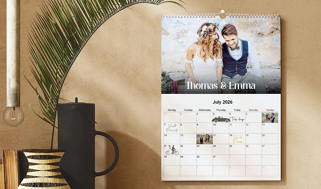 Personalised wall calendar featuring a couple's photo, July 2025 dates, & space for personal photos.  Create your bespoke memory keeper!