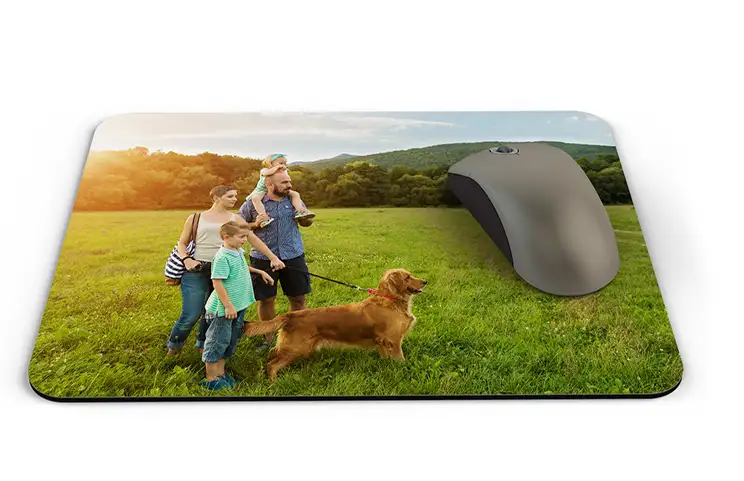 Personalised mouse mat featuring a happy family with their dog in a sun-drenched field.  Create your own unique design!