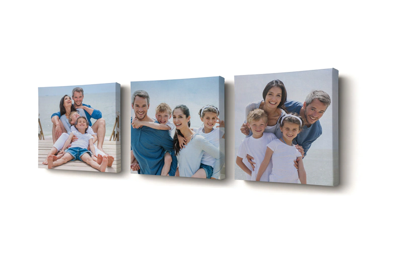 Mom and four young kids sitting on sofa in front of four photo canvases