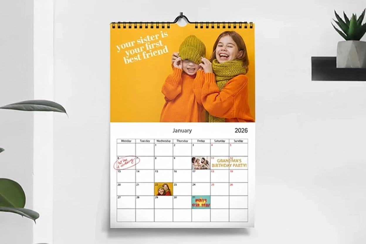 Romantic couple in living room with personalised 2020 wall calendar with proposal photo